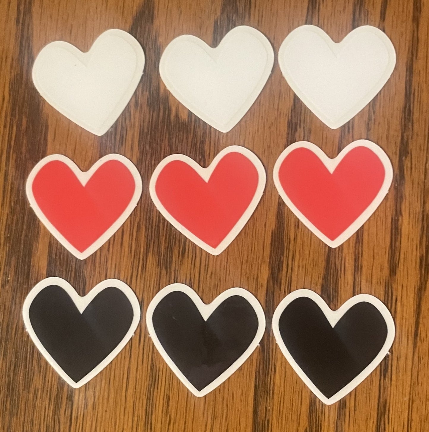 3 black heart stickers, 3 red heart stickers, and 3 white heart stickers shown. Each sticker is 1x1 inch, with clear dye cut edges.